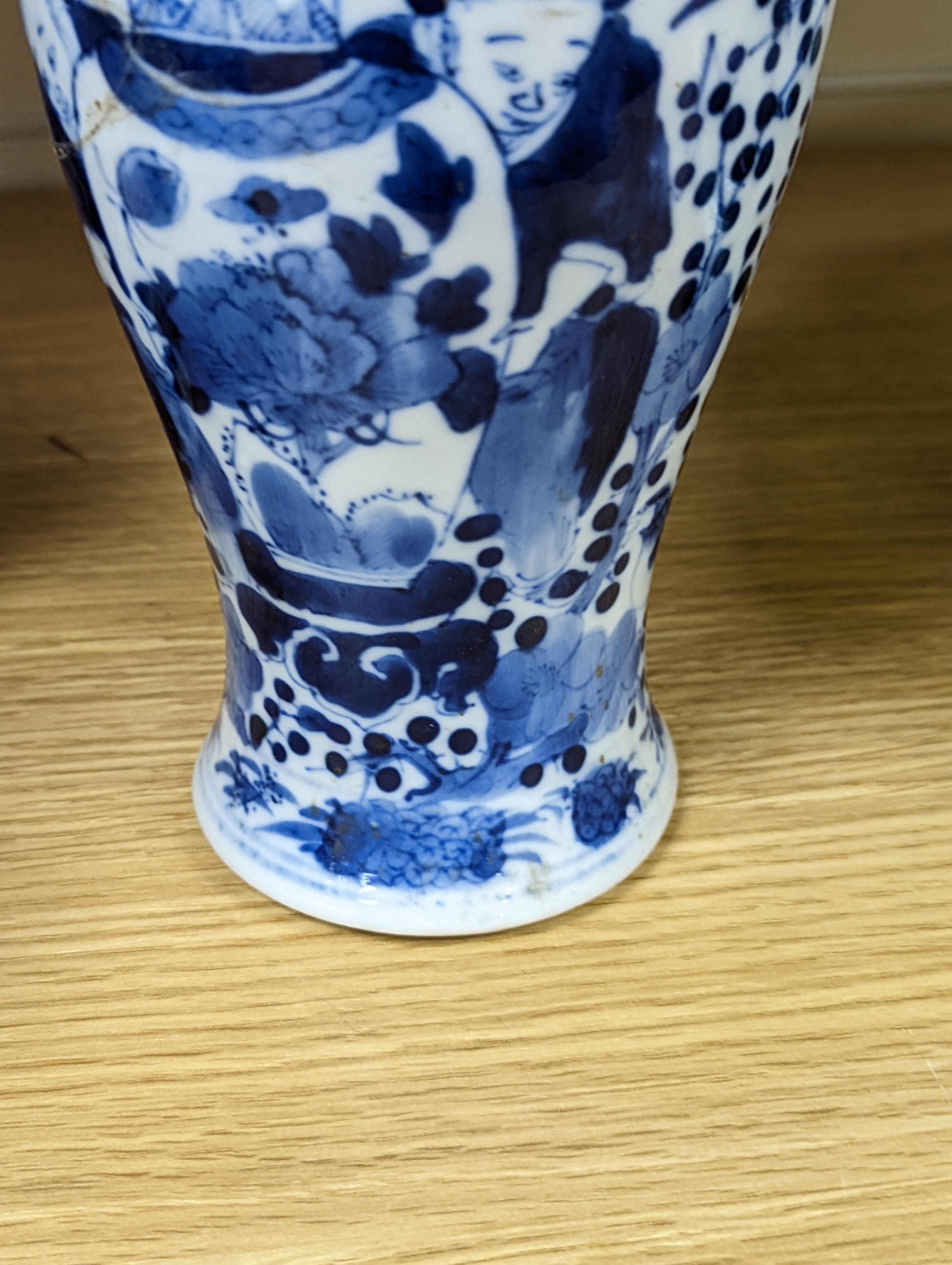 A pair of 19th century Chinese blue and white vases, a prunus vase and cover and a similar jar (4), pair of vases 24 cms high.